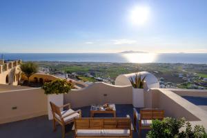 a view of the ocean from the balcony of a villa at Themis Goddess Cave Suites in Santorini