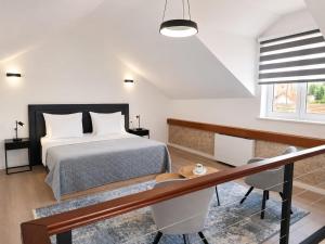 a bedroom with a bed and a desk and a window at Hidden Heritage in Skradin