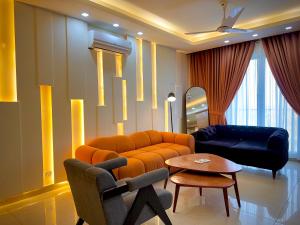 a living room with an orange couch and a table at 1 Bedroom Premium Executive Apartments DHA Lahore in Lahore