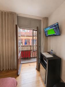 a room with a flat screen tv on the wall at Guest House Vimaranes in Guimarães
