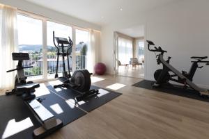 a gym with treadmills and exercise equipment in a apartment at Hotel Maison Forge - Ex Hotel ASTORIA- Saint Etienne-Centre des Congrès- in Saint-Étienne