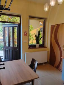 a dining room with a table and a window at Willa Aronia in Szczawnica