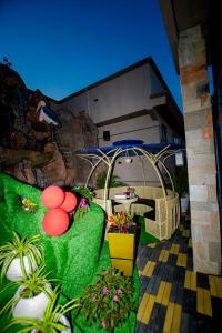 a patio with a table and chairs and plants at IGAWILO RESIDENCE Hotel in Dodoma