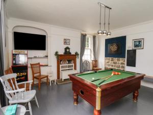 a living room with a pool table at Reighton House in Filey