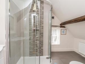 a bathroom with a shower in a attic at Reighton House in Filey +61 photos