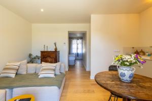 a living room with a couch and a table at Domaine Croix-Maro in Caux +34 photos