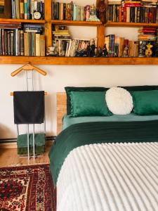a bedroom with a bed with a book shelf with books at ROSE ROOM for 4 guests in green Rose resort Ljubljana in Ljubljana