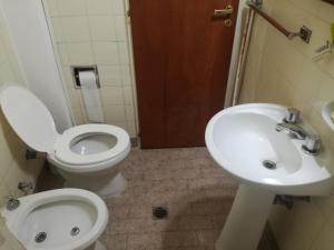 a bathroom with a toilet and a sink at Centro Obelisco in Buenos Aires