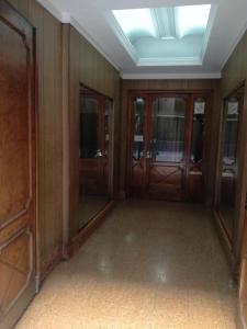 an empty room with wooden walls and glass doors at Centro Obelisco in Buenos Aires