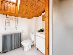 a bathroom with a toilet and a radiator at Le Côte-Rôtie in Vérin