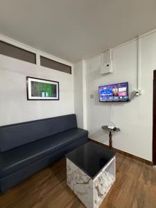 a living room with a couch and a tv at Kesang Stay in Diphu