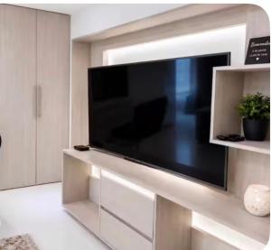 a large flat screen tv sitting on a entertainment center at Loft Premium El Poblado in Envigado