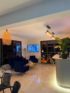 a living room with blue chairs and a blue couch at Vasilia Cove Boutique Hotel in Nicosia