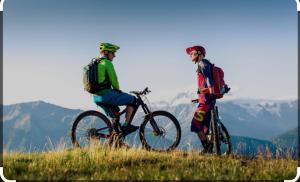two men standing on a hill with their bikes at La Scaletta in San Colombano