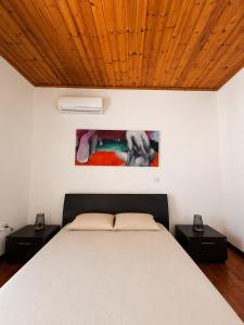 a bedroom with a bed with a wooden ceiling at Jasmine House Egkomi in İncirli