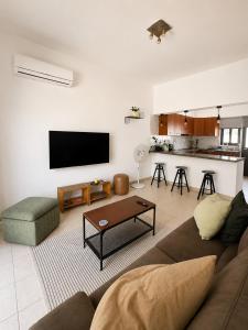 a living room with a couch and a table at Jasmine House Egkomi in İncirli