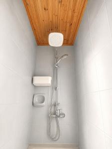 a shower in a bathroom with a wooden ceiling at Jasmine House Egkomi in İncirli +11 photos