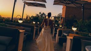 a woman in a wedding dress is walking down a sidewalk at Todos Santos Boutique Hotel in Todos Santos
