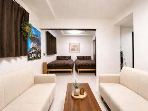 a living room with two couches and a table at Excel 琴似 -FIX HOME- in Sapporo