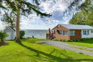 a small house on the shore of a lake at Sunset Views & Deck: Lake Champlain Cottage! in Swanton