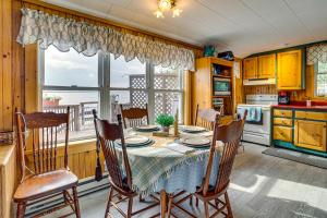a dining room with a table and chairs in a kitchen at Sunset Views & Deck: Lake Champlain Cottage! in Swanton