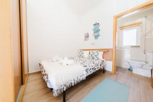 a bedroom with a bed in front of a mirror at Pátio Mariano in Serra de El-Rei
