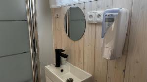 a bathroom with a sink and a mirror on the wall at Salaš Vígľaš in Bojnice