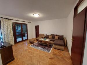 a living room with a couch and a table at PEKOVIĆ in Bar +45 photos