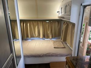 an inside view of a small bed in an rv at Каравана Summer time in Chernomorets