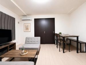 a living room with a couch and a table at Excel 美園 -FIX HOME- in Sapporo +20 photos