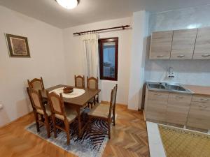 a kitchen and dining room with a table and chairs at PEKOVIĆ in Bar