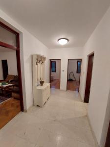 an empty living room with a large room with white walls at PEKOVIĆ in Bar