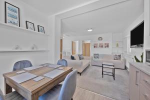 a living room with a wooden table and chairs at 2 Bed Flat 10mins Heathrow 1 Parking EV in Hanworth