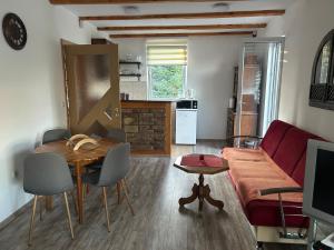 a living room with a red couch and a table at Zeleni kutak in Sarajevo