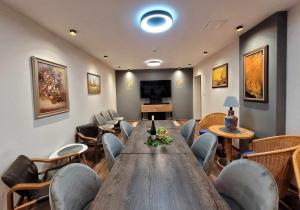 a conference room with a large wooden table and chairs at Főnix Badacsony in Badacsonytomaj