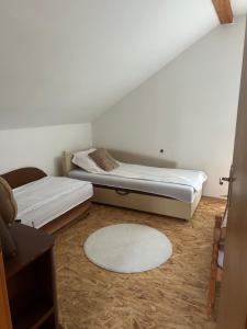 a room with two beds and a rug at Zeleni kutak in Sarajevo