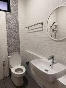 a bathroom with a toilet and a sink and a mirror at CS phangan Villa in Ko Phangan