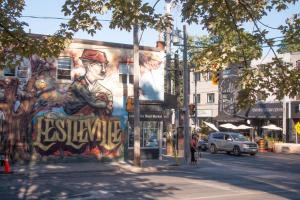 a mural on the side of a building on a street at Casa East Side Hotel Queen East Leslieville Suite in Toronto