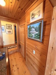 a log cabin with a picture on the wall at Capstone Cottage - Quintessential Cabin on Bay in Gouldsboro +12 photos