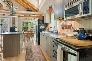 a kitchen with a sink and a stove top oven at The Boathouse in Brighams Cove