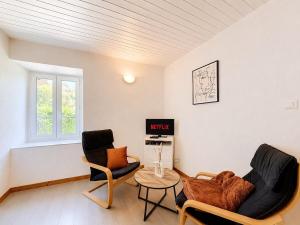 a living room with two chairs and a table at Le Condrieu in Vérin