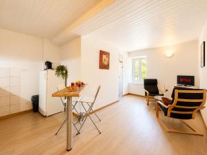 a kitchen and living room with a table and chairs at Le Condrieu in Vérin
