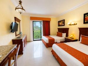 a hotel room with two beds and a television at Gran Real Yucatan in Mérida +53 photos