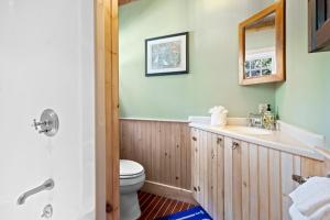 a bathroom with a sink and a toilet at The Boathouse in Brighams Cove