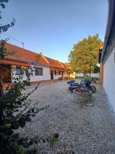 a group of motorcycles parked next to a building at La umbra nucului bătrân in Ghimbav +19 photos