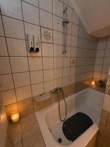 a bathroom with a bath tub with a shower at Madona Casas in Psilá Alónia +4 photos