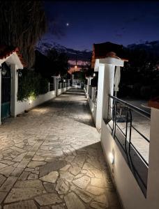 a walkway leading to a house at night at Madona Casas in Psilá Alónia