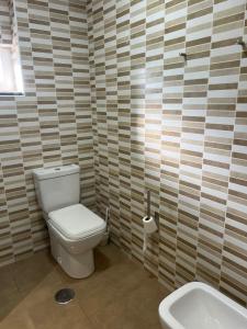 a bathroom with a toilet and a sink at El Refugio de Pedrosa in Pedrosa del Rey +22 photos