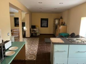 a kitchen with a counter top and a living room at El Refugio de Pedrosa in Pedrosa del Rey