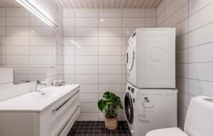 a white bathroom with a sink and a refrigerator at Bualie leilighet in Gol